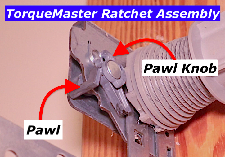 Wayne Dalton TorqueMaster Plus ratchet assembly showing the pawl and pawl knob used when de-tensioning the spring
