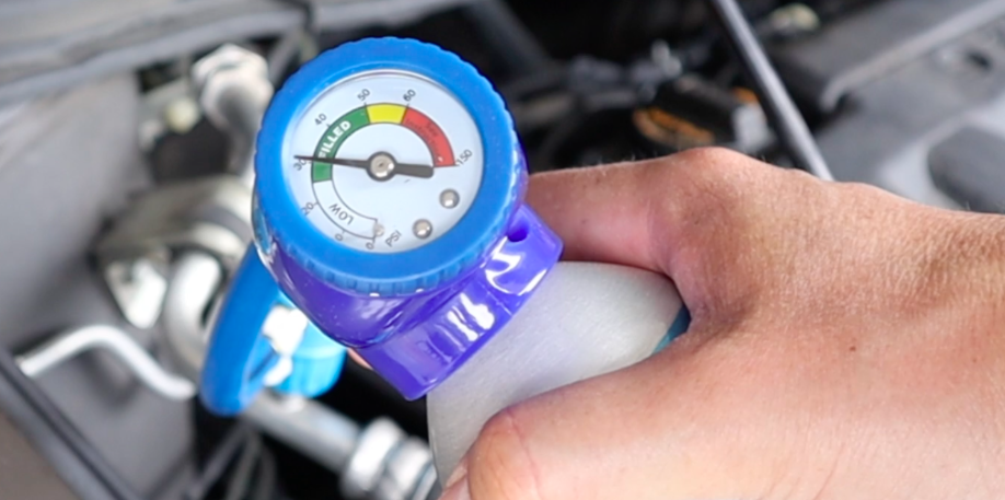 A/C recharge gauge showing proper pressure in the green zone